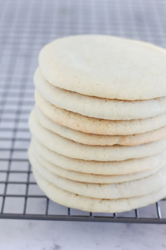 Neuf biscuits empilés sur eux même après cuisson par dessus une grille de cuisson.
